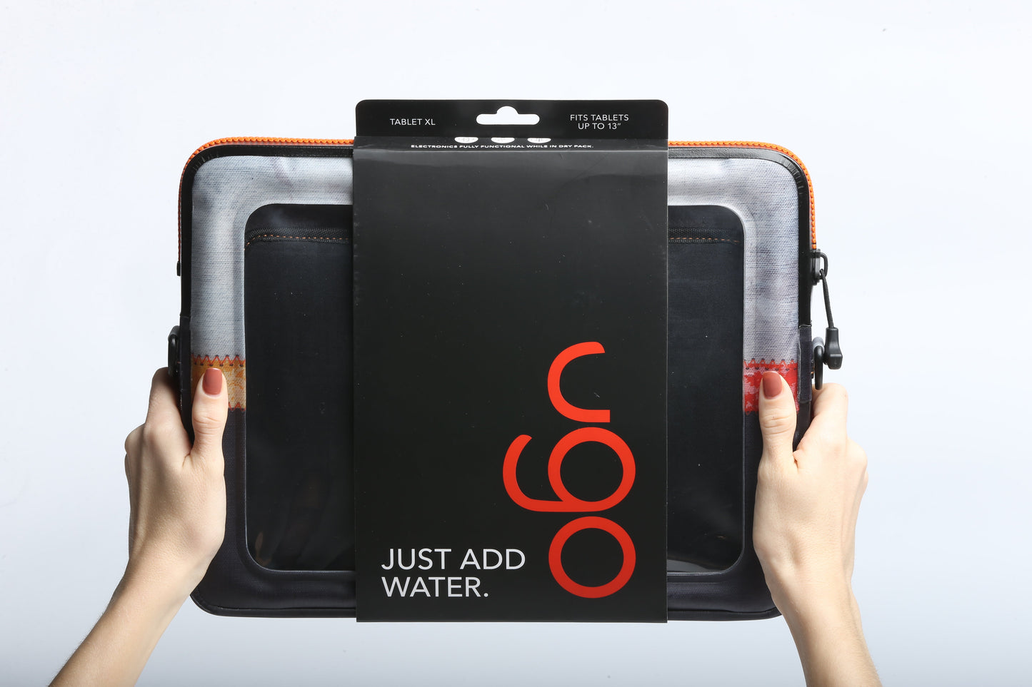 A person holds a black ugo wear ugo® Signature Collection TABLET XL waterproof case in its packaging, labeled "JUST ADD WATER" and "Fits tablets up to 13"," providing electronics protection against a plain white background.
