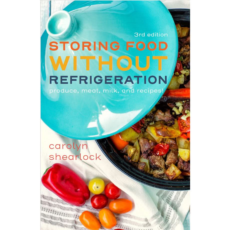 The Boat Galleys cookbook, Storing Food Without Refrigeration, by Carolyn Shearlock, features a top-view vibrant dish in a blue ceramic pot surrounded by colorful bell peppers and tomatoes on white cloth—ideal for creating fresh meals wherever you are!.