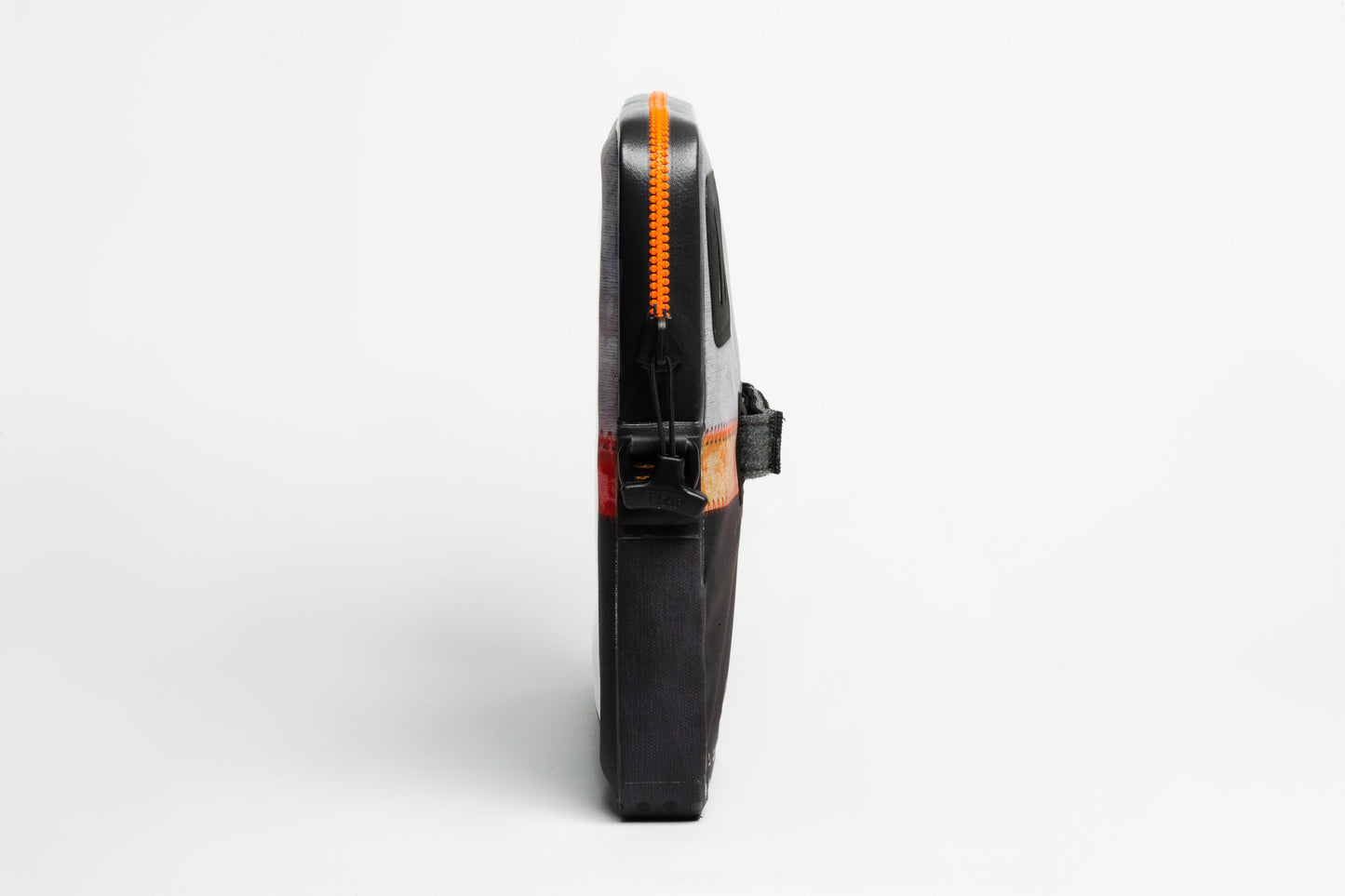 A black, semi-hard Scratch N Dent ugo® Signature Collection TABLET case by ugo wear stands upright on a white background, featuring a vertical orange zipper along its edge and a side black strap.