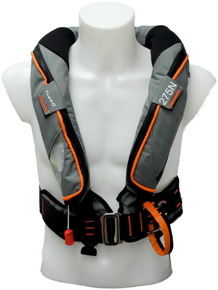 A torso mannequin displays the Cruising Solutions TeamO PFD with BackTow™ - Ocean Grey ProSensor Elite, an inflatable harness with orange trim, labeled 275N. It features buckles, straps, a pull cord, and advanced BackTow™ marine safety technology.