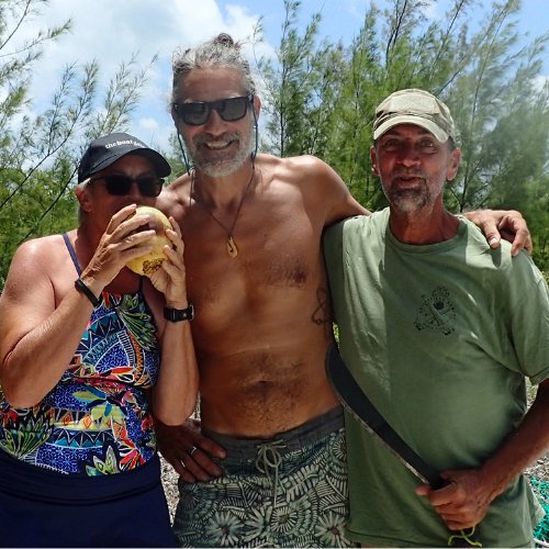 Carolyn Shearlock, John Herlig, and Larry Webber on a beach in the Bahamas, representing experienced cruisers behind The Boat Galley’s trusted resources for living aboard and cruising.