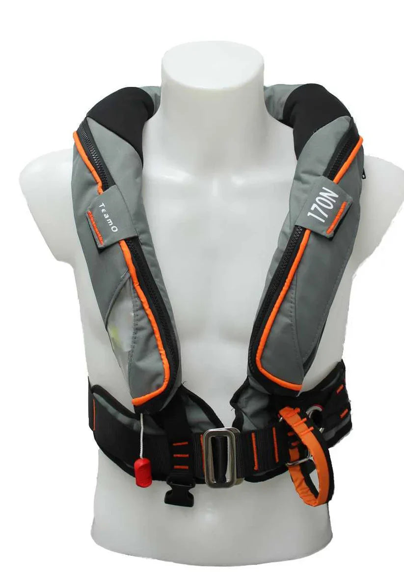 A Cruising Solutions TeamO PFD with BackTow™—Offshore Grey Hammar is shown on a white mannequin. It features BackTow™ Technology, safety buckles, harness, visible labels, orange trim, and a red pull tab.