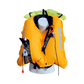 The Cruising Solutions TeamO PFD with BackTow™ - Offshore Black Hammar is shown on a white mannequin torso. This lifejacket features reflective strips, black straps, manual inflation tube, CO2 cartridge, and innovative BackTow™ Technology.