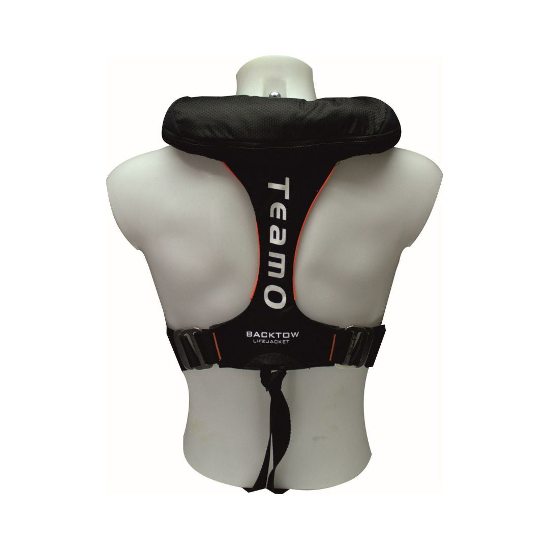 A white mannequin torso displays a Cruising Solutions TeamO PFD with BackTow™ - Offshore Black Hammar, featuring white text, visible shoulder straps, side buckles, and a crotch strap. The view is from the back.